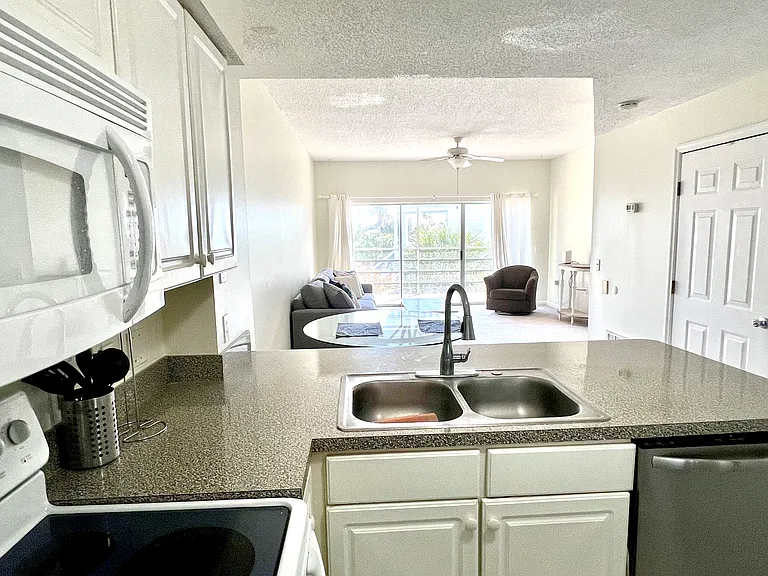 view looking across kitchen into living area