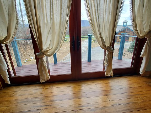 Sliding glass doors in the living room area open to the small balcony.