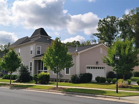 Side view of home with back load garage and screened porch