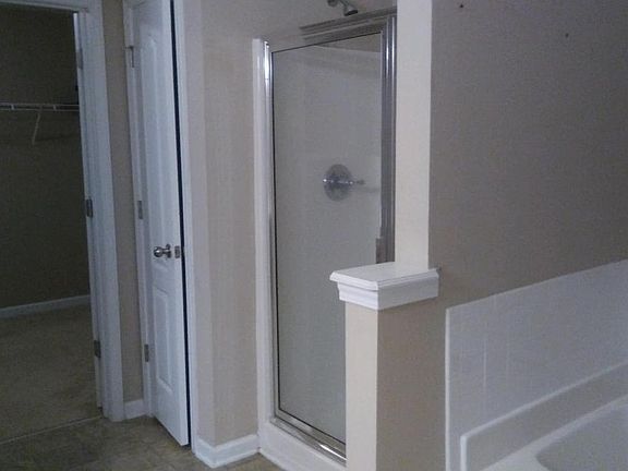 Part of master bathroom with jetted tub and shower double si