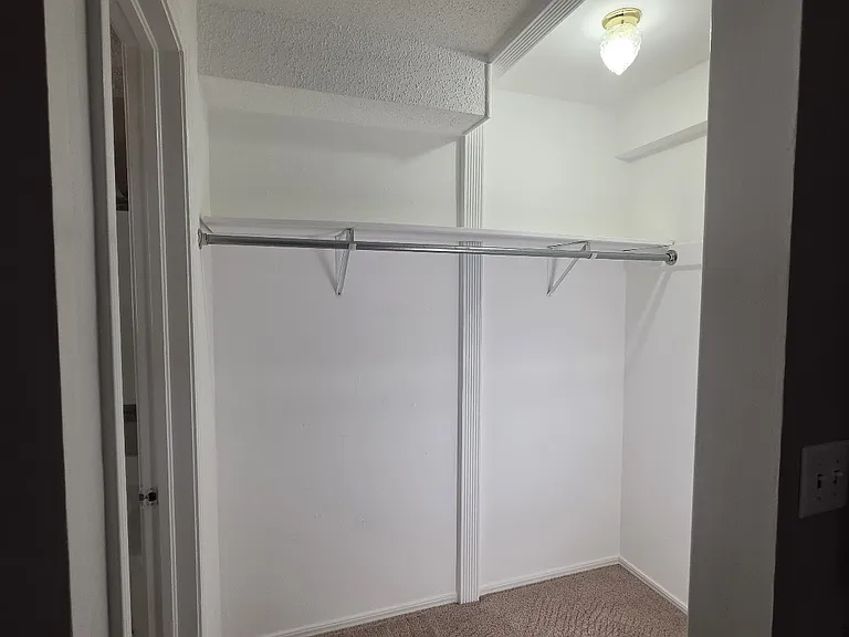 Walk-in closet in primary bedroom.