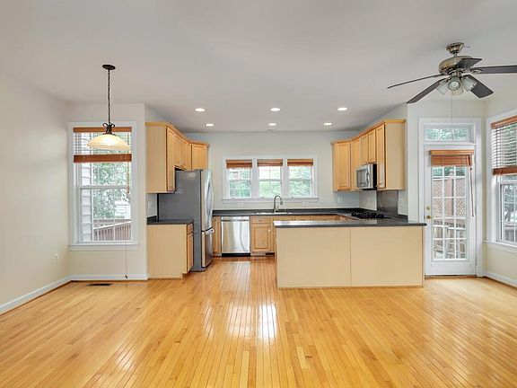 Kitchen has new stainless steel appliances and plenty of storage. It is flanked by family room and breakfast nook. Access deck from family room through the door on the right. Pantry is near the nook.