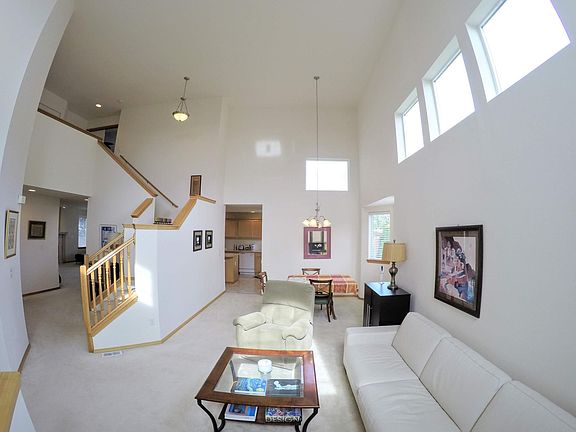 Open concept floorplan includes sitting room, dining room, kitchen, office/additional bedroom, bath, and family room with fireplace