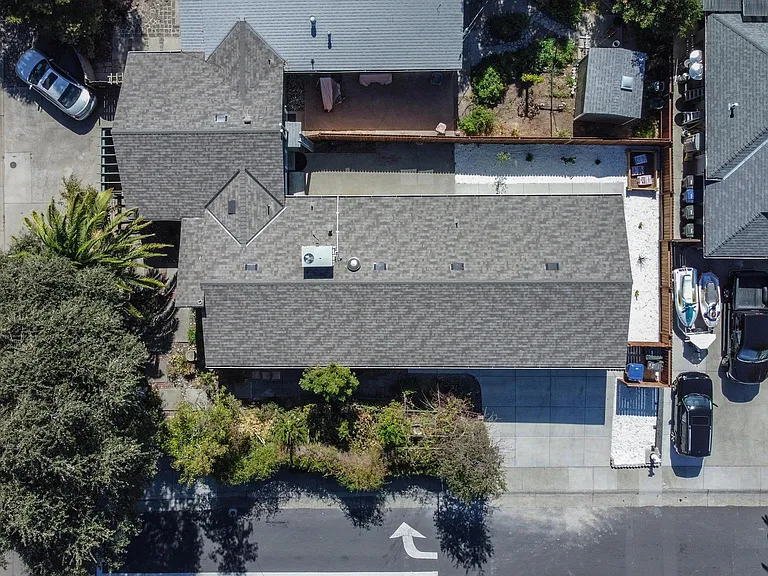 Arial of property. Dark grey roof is this address/listing. Parking in front of or in garage only.