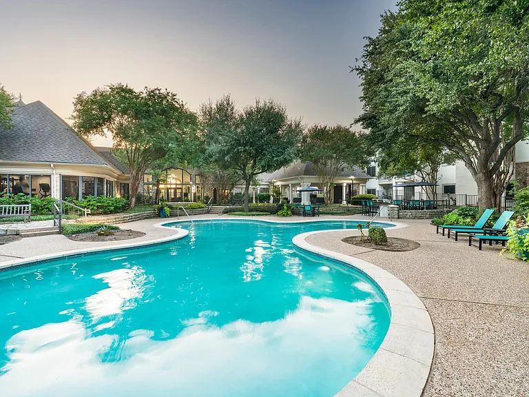 Surrounded by mature trees and thoughtful landscaping, the resort-style pool invites quiet moments or casual conversation poolside.