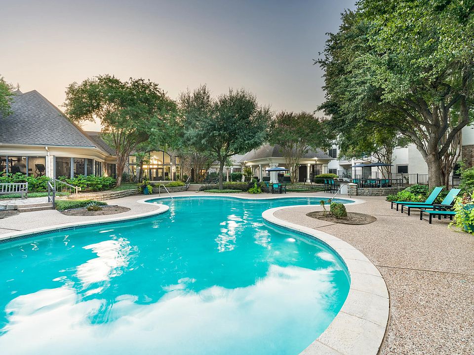 Surrounded by mature trees and thoughtful landscaping, the resort-style pool invites quiet moments or casual conversation poolside.