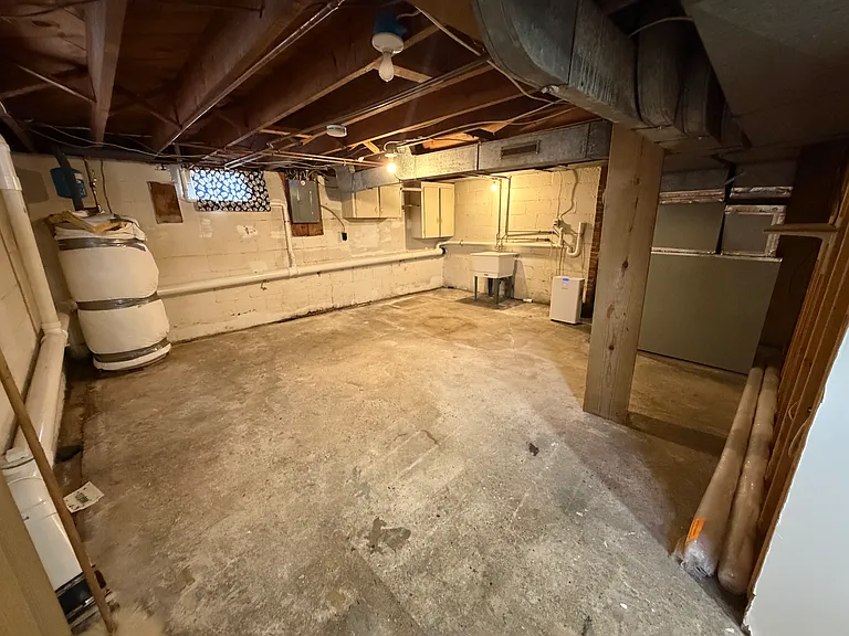 Main basement area. Concrete floors throughout. Can be used as rec room, "man cave", hobby space, etc. Features washer/dryer hook-up, utility sink, new dehumidifier, with easy access to electric box, HVAC unit and water heater.