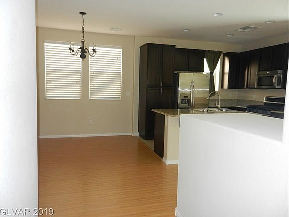 Enter the front door and look into the dining area and Kitchen
