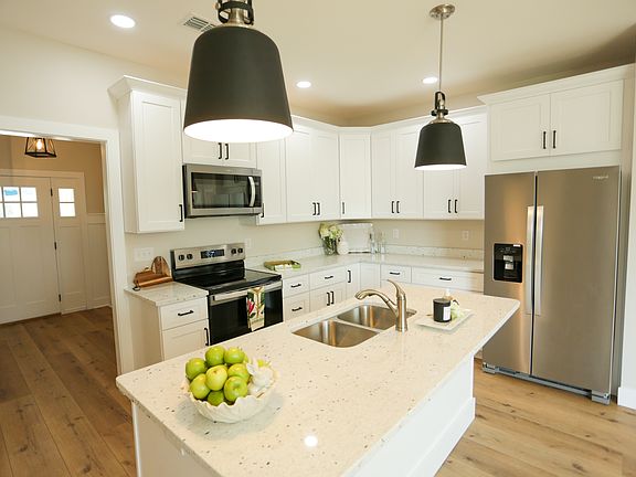 Back cottage custom cabinets, large kitchen island accommodates four stools