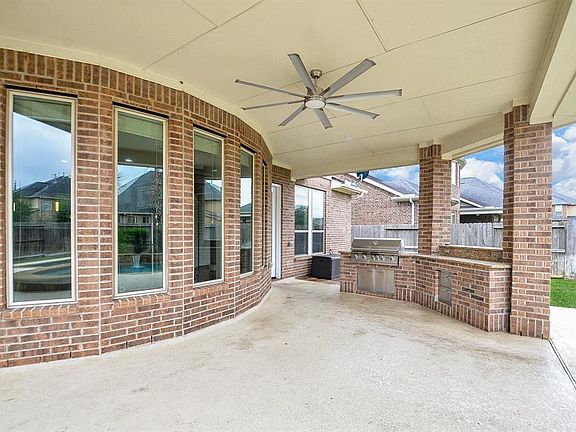 View from the outside patio of the windows in the Family Room and a picture of the Outdoor Grill and kitchen area.