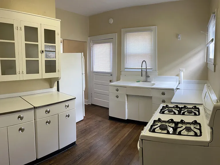 Kitchen, view 2 - back door opens onto deck, fully fenced yard and garage.