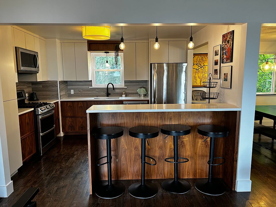 Kitchen with gas stove, double oven including convection oven, custom cabinetry with hidden drawers for streamlined look.