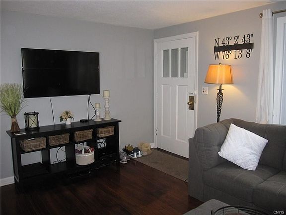 After a little entryway, you come in through the front door.  Notice the hardwoods, the grey paint...