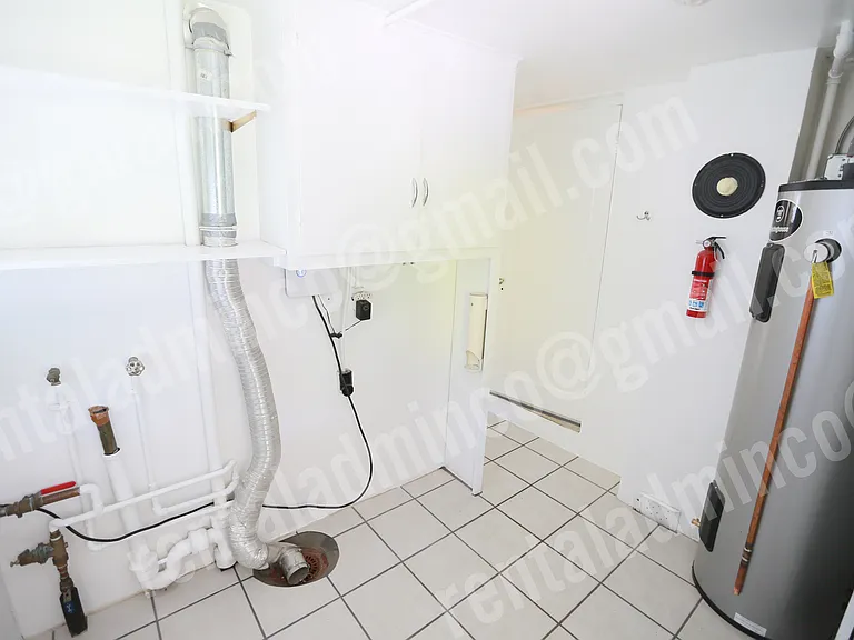 Laundry Hookups and utility room with new 60 gallon water heater.