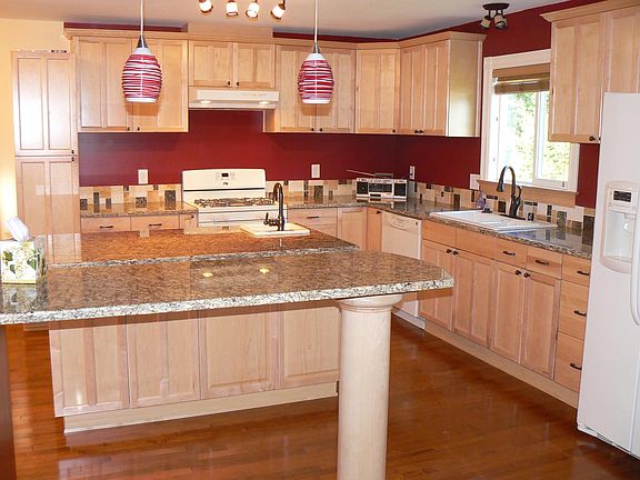 Spacious new kitchen with bar, island with bar sink, granite