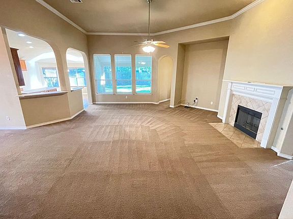 Large open floor plan family room with the formal dining room on the far left, the kitchen on the left and the master bedroom to the slight right, overlooking the backyard