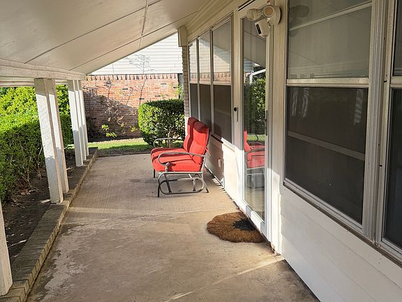 Front covered porch with red swinging couch (included).