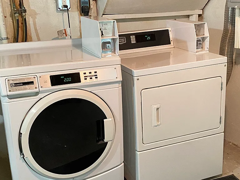 Basement coin-op laundry for building.