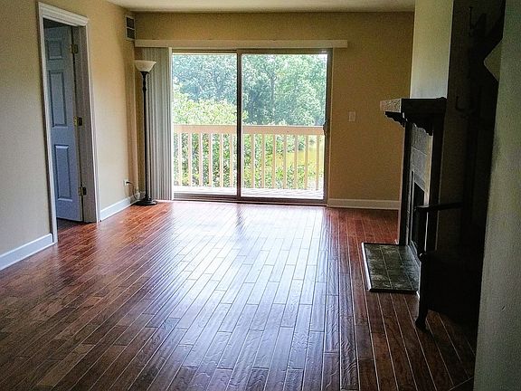 Great view of pond! Private balcony. Newer wood flooring and gas fireplace.