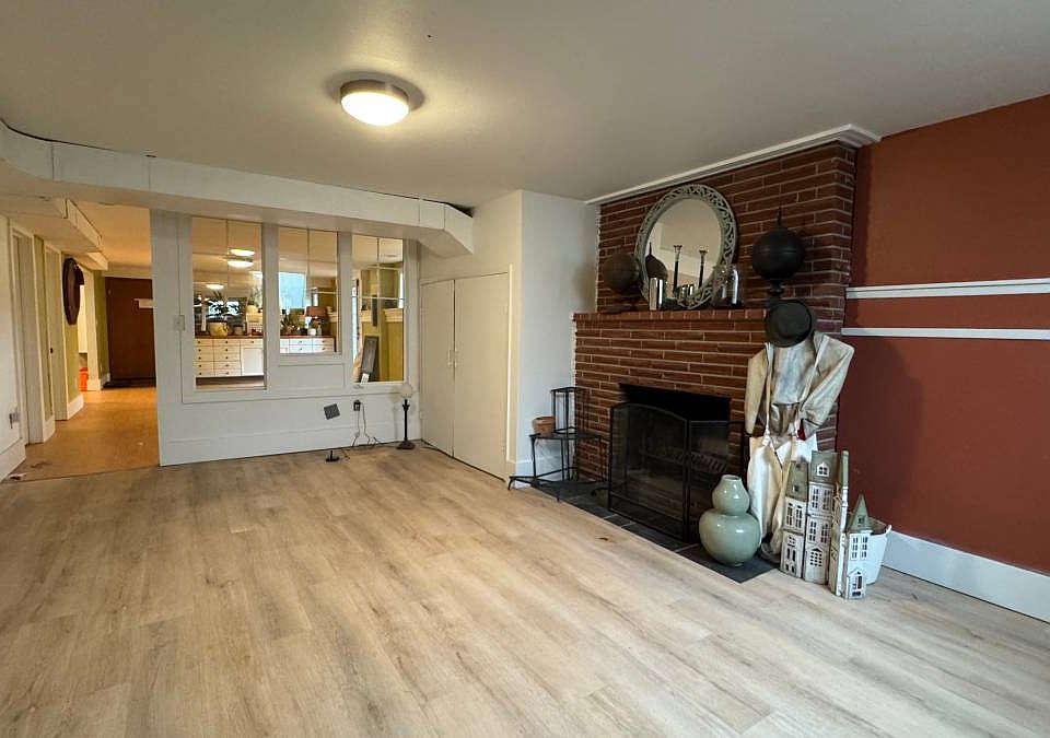 Family room with wood-burning fireplace.