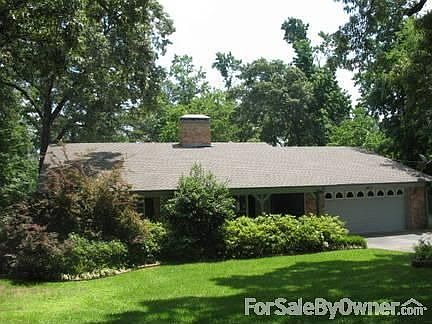 Large trees punctuated by established professional landscaping 