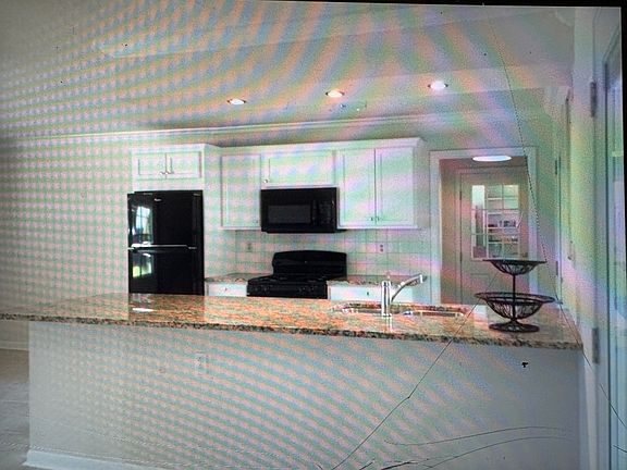 Bright kitchen opens to dining/living areas