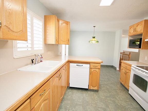 Kirchen with dishwasher, range, microwave, and refrigerator