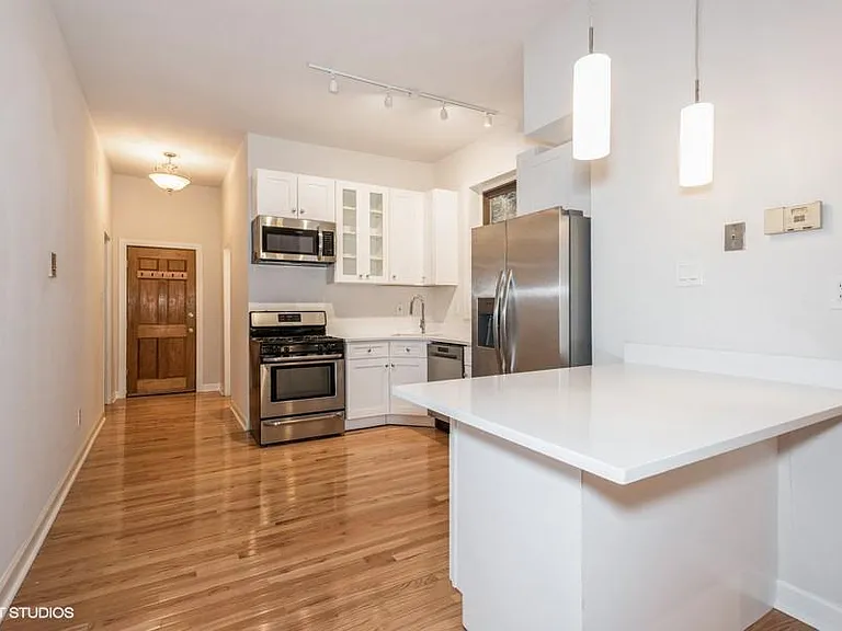 Open kitchen with quartz countertops and brand new stainless steel appliances