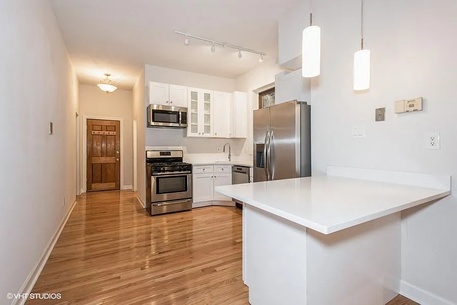 Open kitchen with quartz countertops and brand new stainless steel appliances