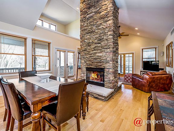 Spacious dining area with stone fireplace.