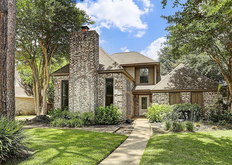 Lovely brick home with mature trees in well established neighborhood