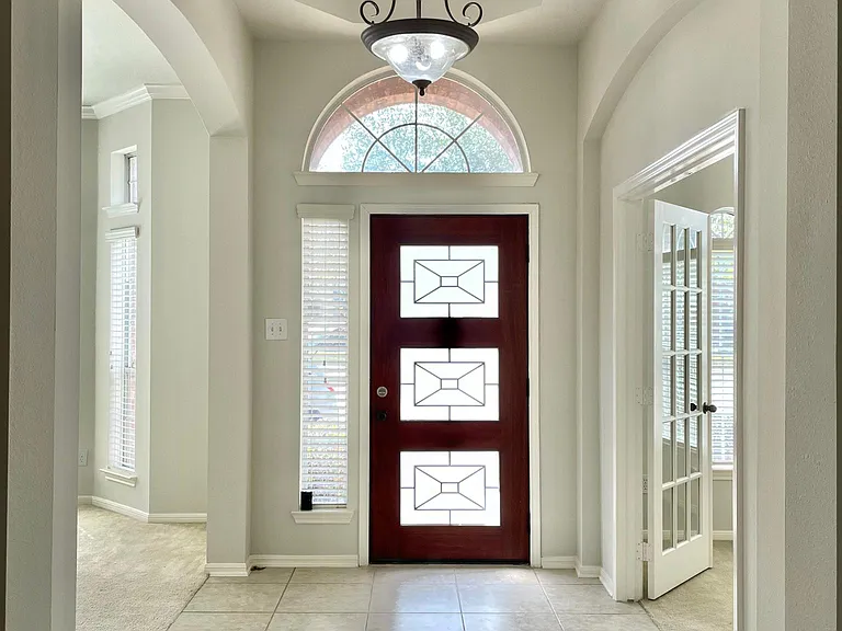 Inviting foyer with high ceilings providing a warm welcome into the home.