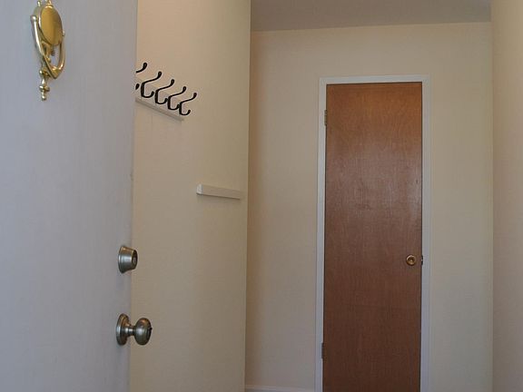 Front entryway. Kitchen opens off to the right, bedrooms are straight ahead and left, living room straight ahead and right.