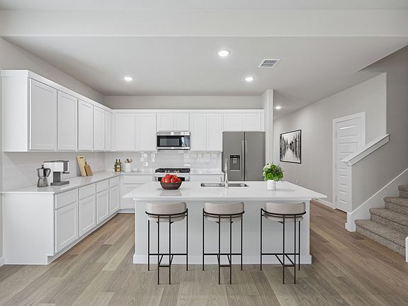 Kitchen in the Stanley II home plan by Trophy Signature Homes - REPRESENTATIVE PHOTO