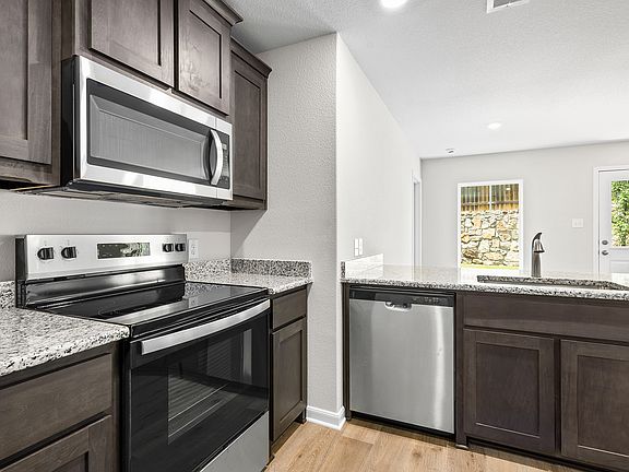 The kitchen has sprawling granite countertops.