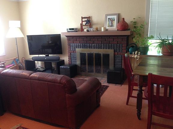Living Room area with working, wood-burning fireplace.
