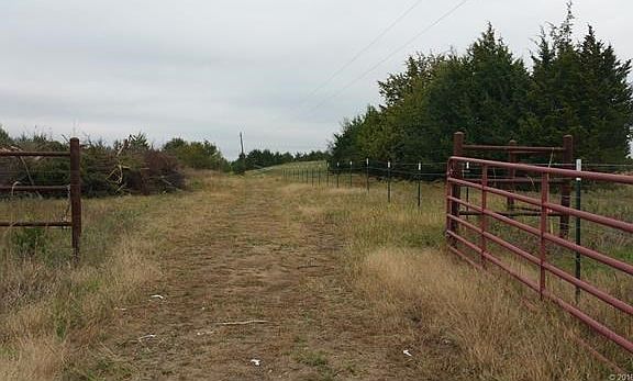 This gate is the entrance to the property. Land right of new fence is not part of property