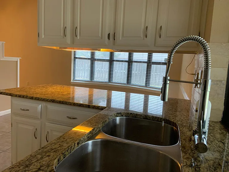 Undermount kitchen sink with faucet overlooking breakfast area