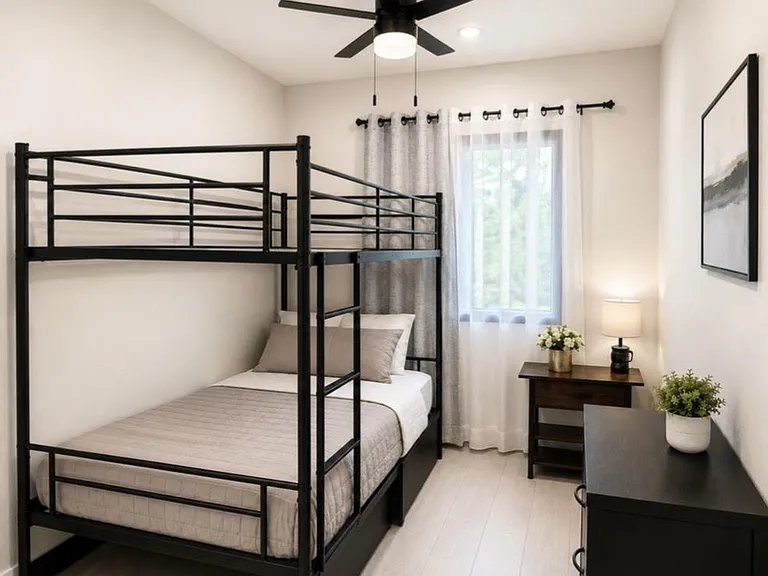 Furnished bedroom with a bunk bed, ceiling fan, and window with curtains, plus a nightstand and dresser for storage.