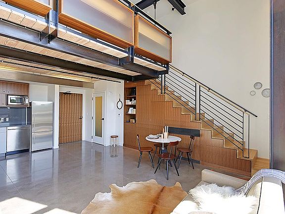 Polished concrete and steel I-beams compliment the real wood accents throughout, providing a throughly modern/industrial feel.