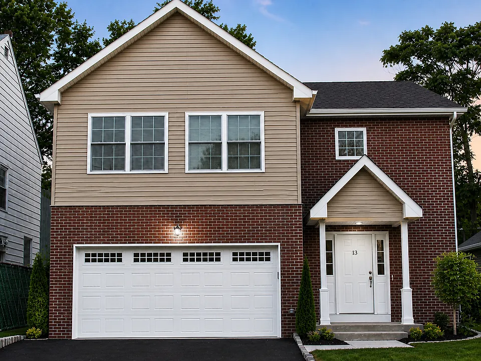 Modern newly built home with private driveway and brick facade.
