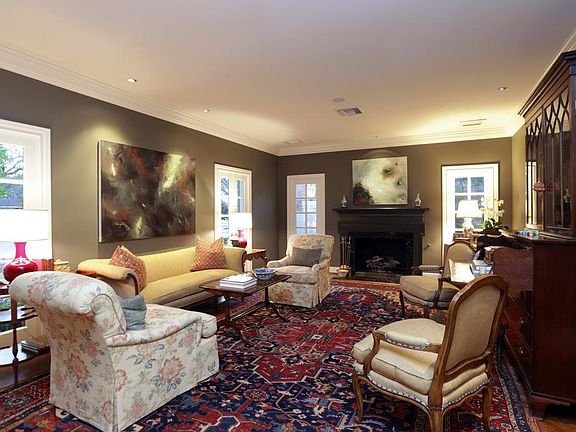 LIVING ROOM (24' x 14') - spacious, light filled Formal living area with pair of French doors overlooking front lawn, fireplace flanked by floorlength windows, nine foot ceilings, custom wood floors, Lutron lighting, speakers, double crown moulding.