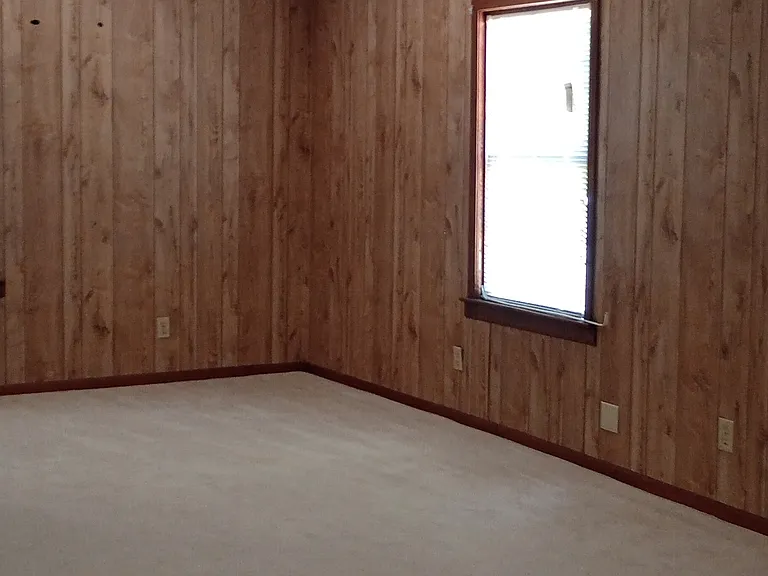 Large bedroom has three windows
