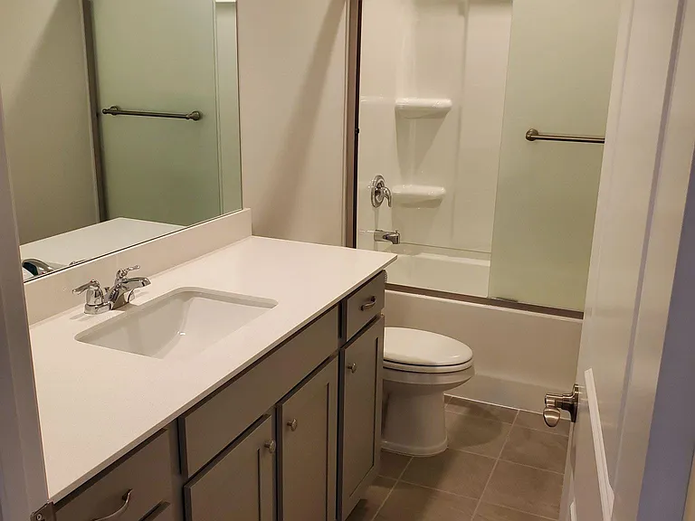 Second full bathroom upstairs with frosted glass shower door
