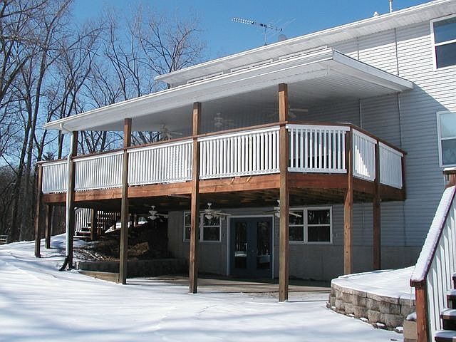 Deck above patio has ceiling fans