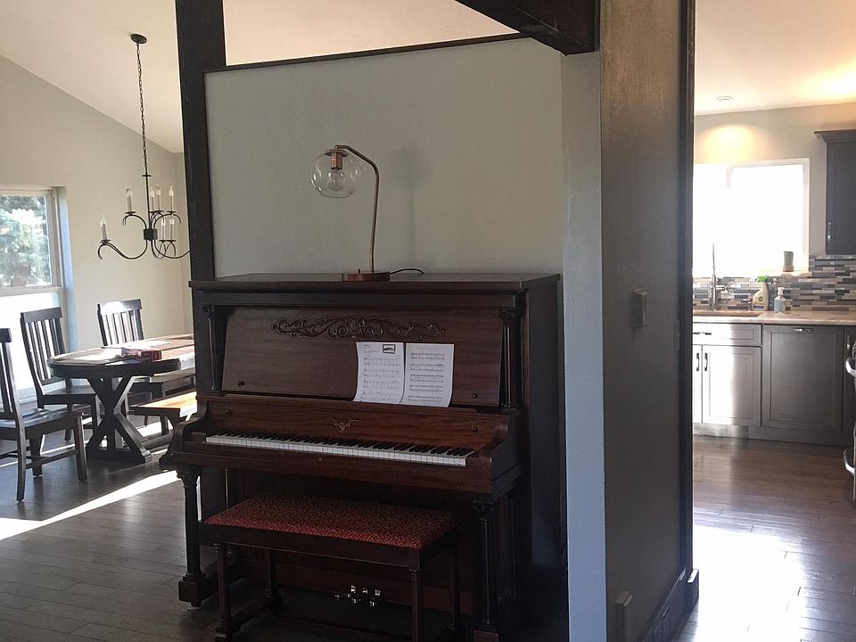 Piano on wall between living room and kitchen