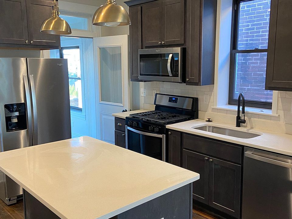 Kitchen with Quarts countertops and tile backsplash