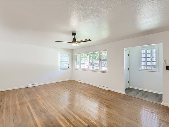 Main floor living room, newly finished flooring, new lighting and ceiling fan