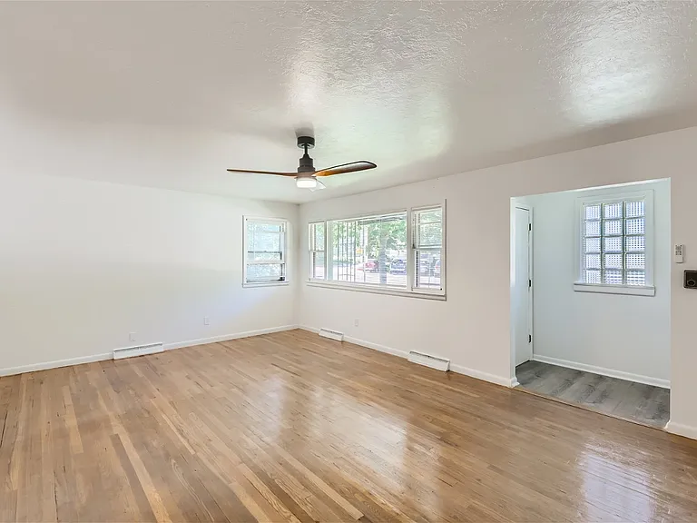 Main floor living room, newly finished flooring, new lighting and ceiling fan