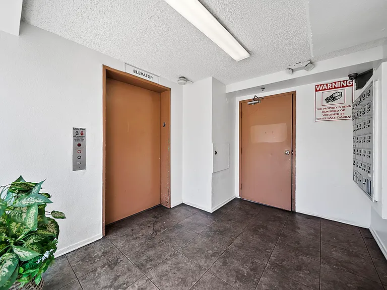 Interior lobby featuring elevator access and controlled entry.